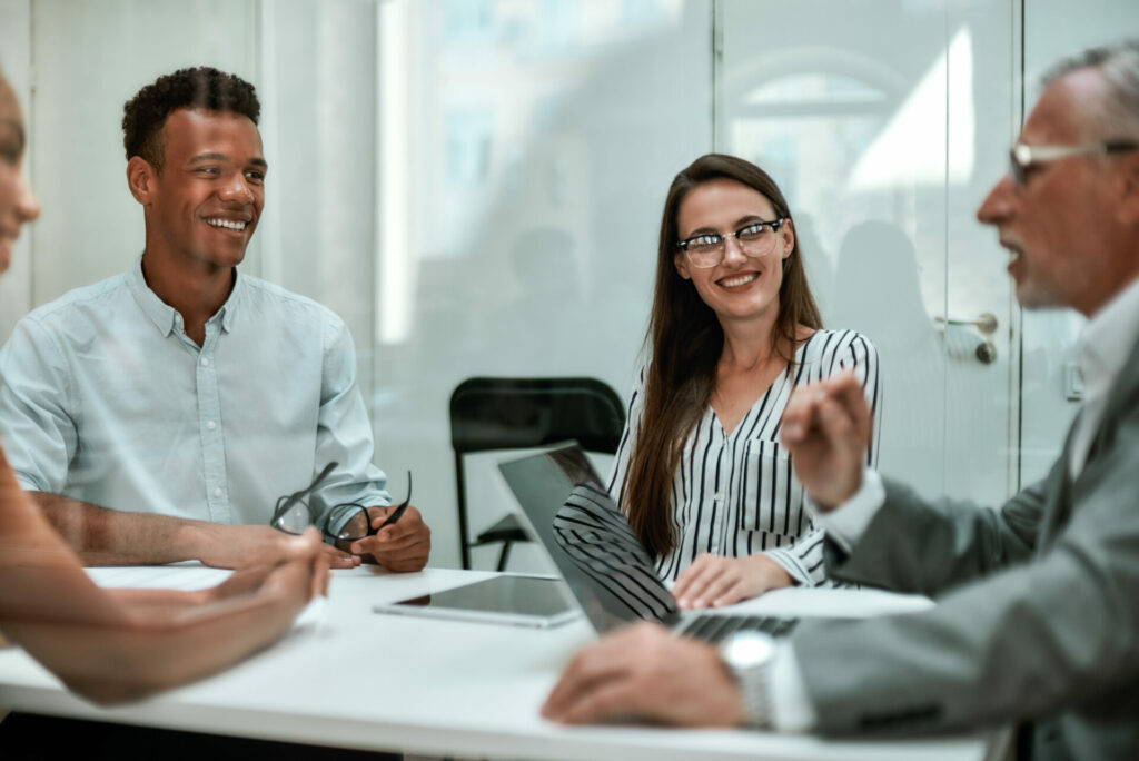 young and cheerful coworkers smiling